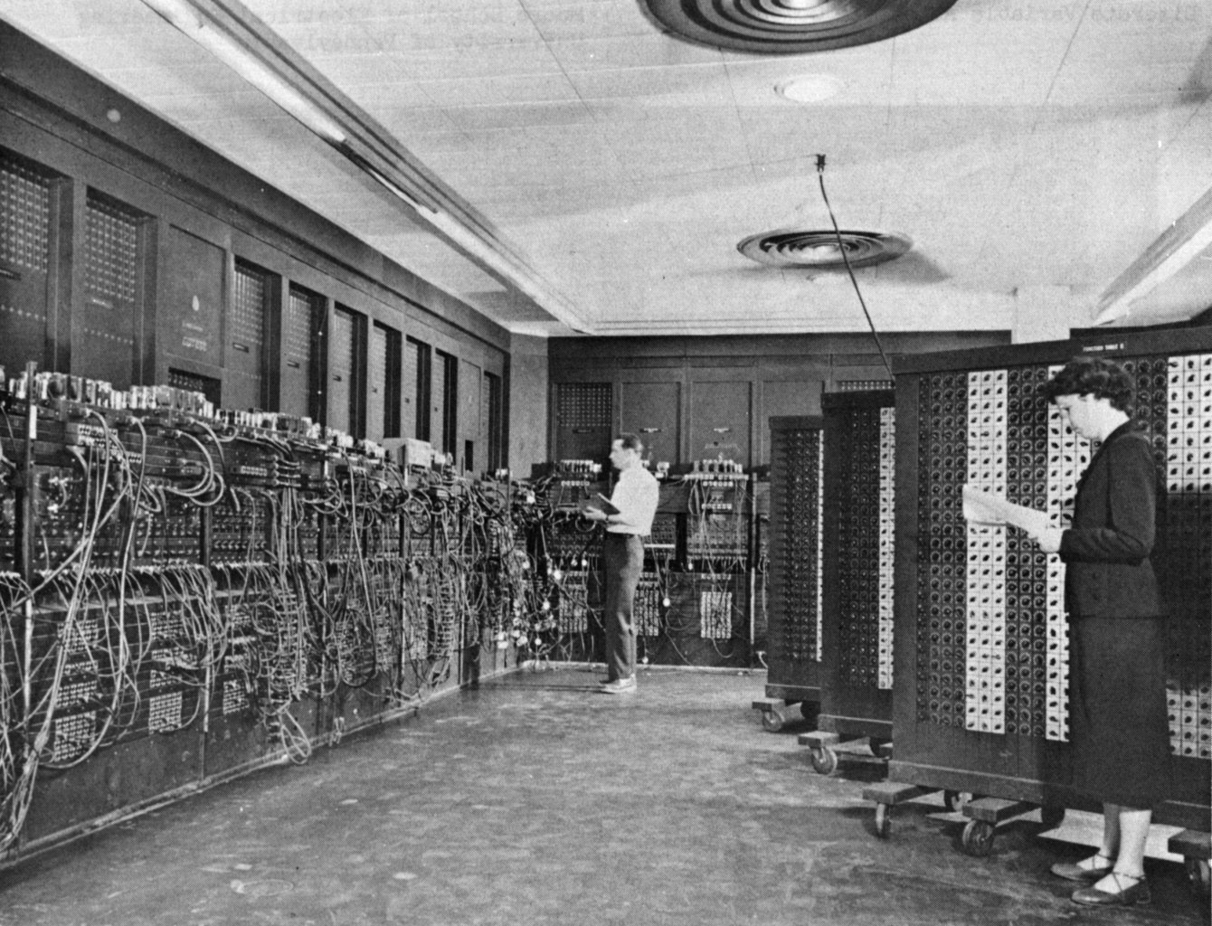 People programming ENIAC. They plugged in cables and set switches in front of a calculator that filled an entire room