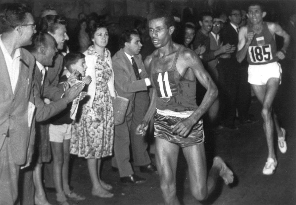 Abebe Bikila running barefoot in the marathon at the 1960 Rome Olympics. He won the race running barefoot. Public domain (Italy), Wikimedia Commons
